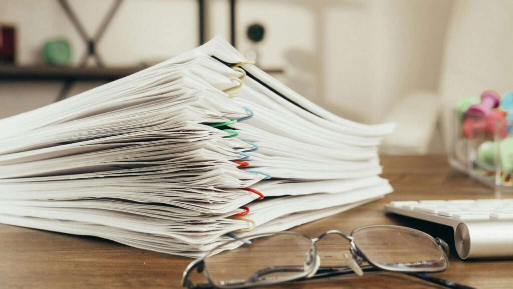 Pile of paperwork representing documents required to apply for a merchant cash advance