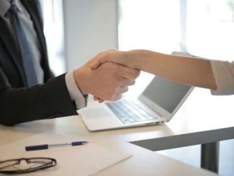A happy Canadian business owner gets an unsecured loan with a Bizfund advisor without risking their assets.
