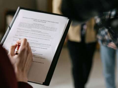 Entrepreneur organizing documents to apply for a business loan in Canada