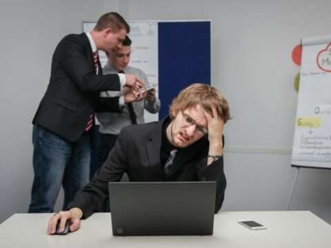 Entrepreneur filling out a business loan application and reviewing documents carefully.