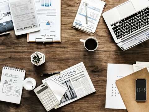 Entrepreneur reviewing documents to leverage government grants and loans for business growth.