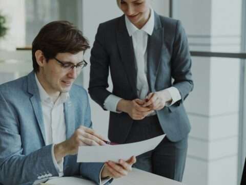 Small business owner using a laptop to explore government loan programs in Canada.