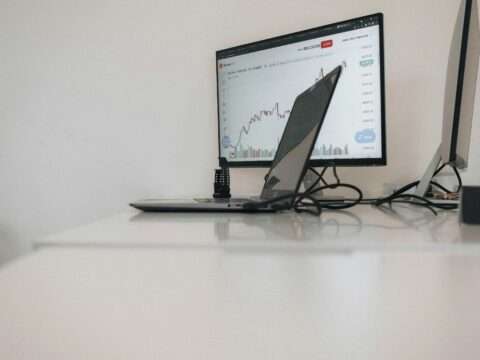 Essential digital tools for Canadian small businesses illustrated on a laptop and smartphone.