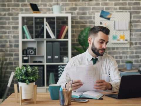 Canadian borrower reviewing documents to understand loan insurance coverage and protection options